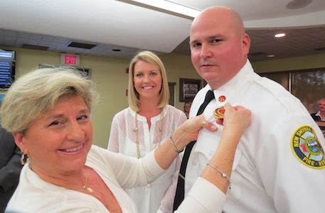 NSB firefighter Bill Crapps gets a promotional pin at City Hall / Headline Surfer®