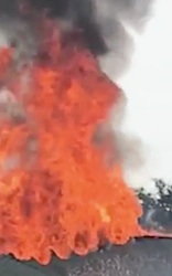 Flames shoot through the roof of a home on Mayton Road in Oak Hill, FL on Saturday before it collapses / Headline Surfer