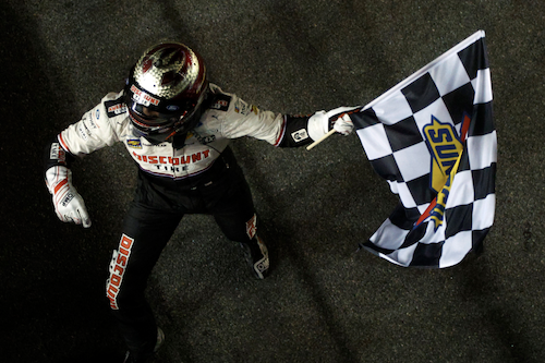 Austin Cindric waves checkered flag / Headline Surfer