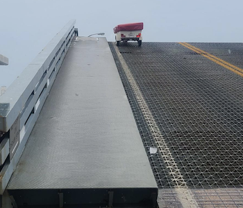 Bike dangles from Main Street Bridge / Headline Surfer